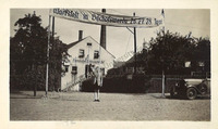Front, Madden posing under sign, 1936